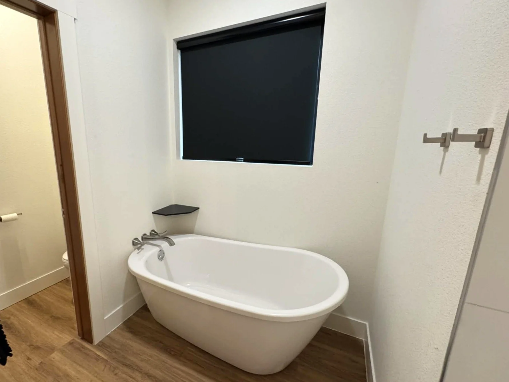 Freestanding soaking tub inside modern bathroom at The Overlook on Mountain View vacation rental in the Black Hills