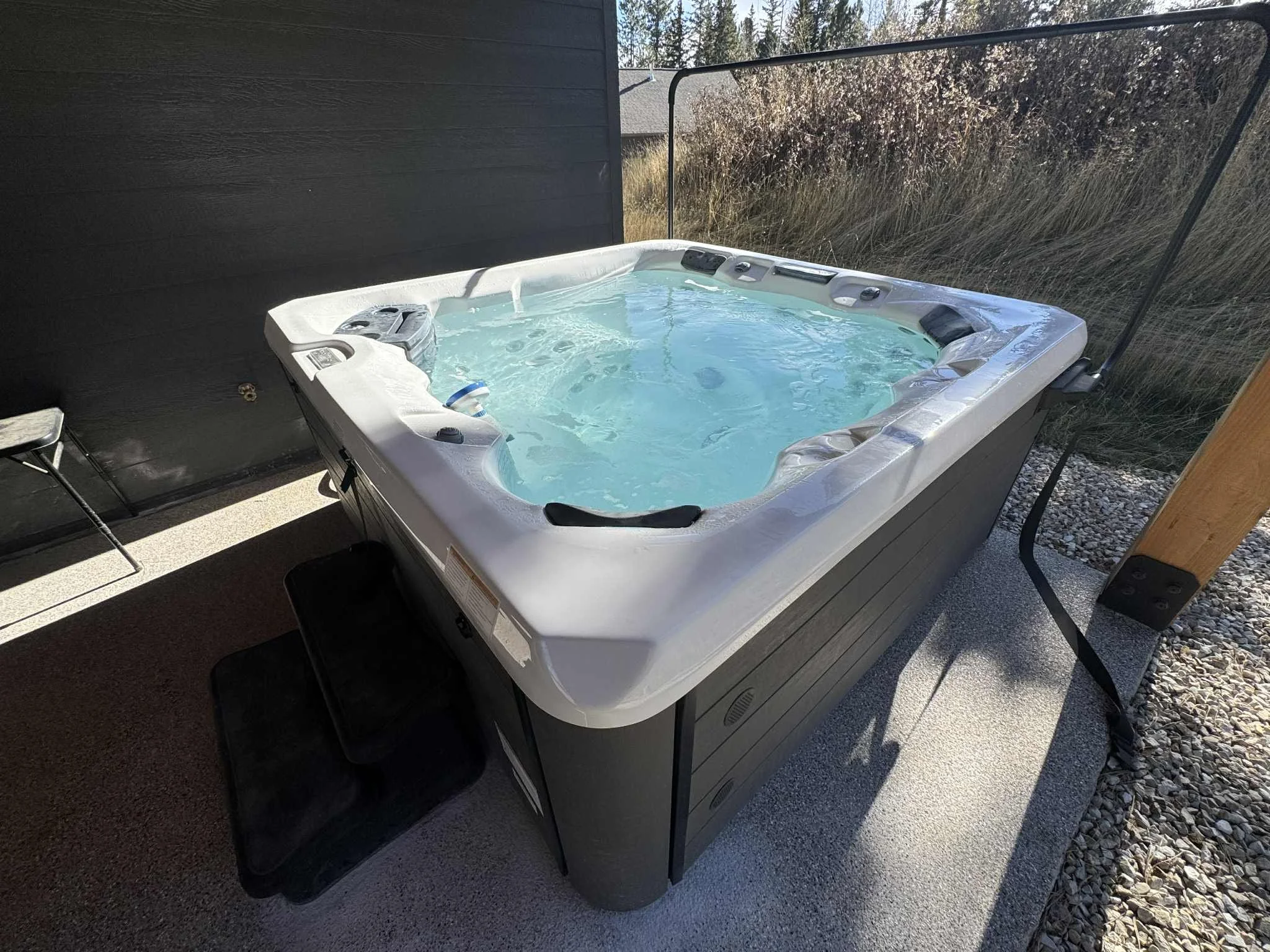 Private outdoor hot tub at Champagne & Ice vacation home in Lead, South Dakota – surrounded by trees and mountain air, perfect for relaxing after a day of adventure.