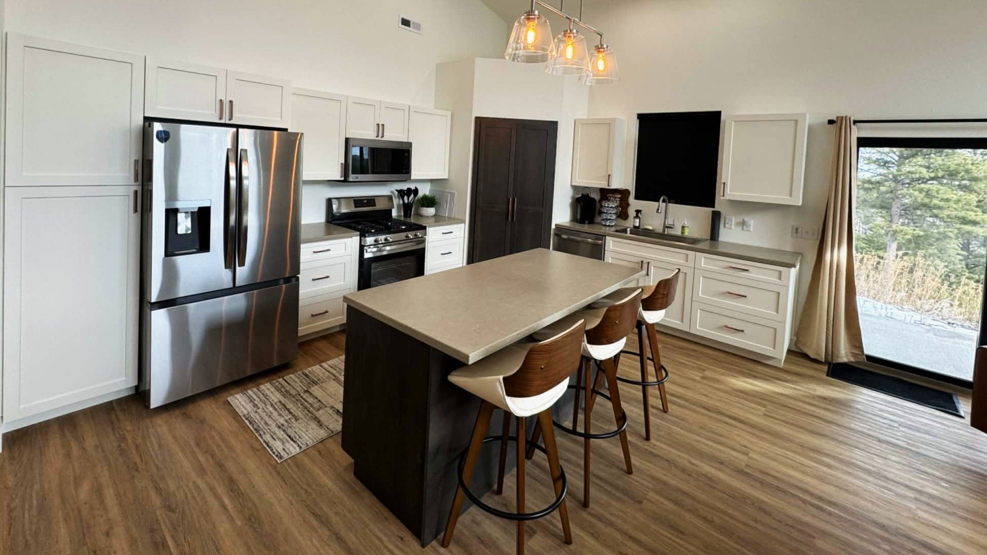 Bright open kitchen with island and stainless appliances at The Overlook on Mountain View Black Hills vacation rental near Deadwood
