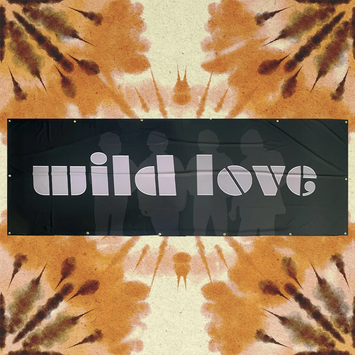 A black banner with the words "wild love" in large white font, hanging against a colorful, abstract background with orange and brown streaks and silhouettes of people in the background.