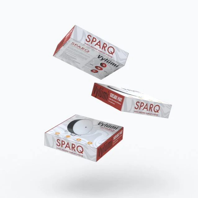 Three boxes of sparq vinyl record display system, with one box open revealing a white vinyl record and a black tonearm.
