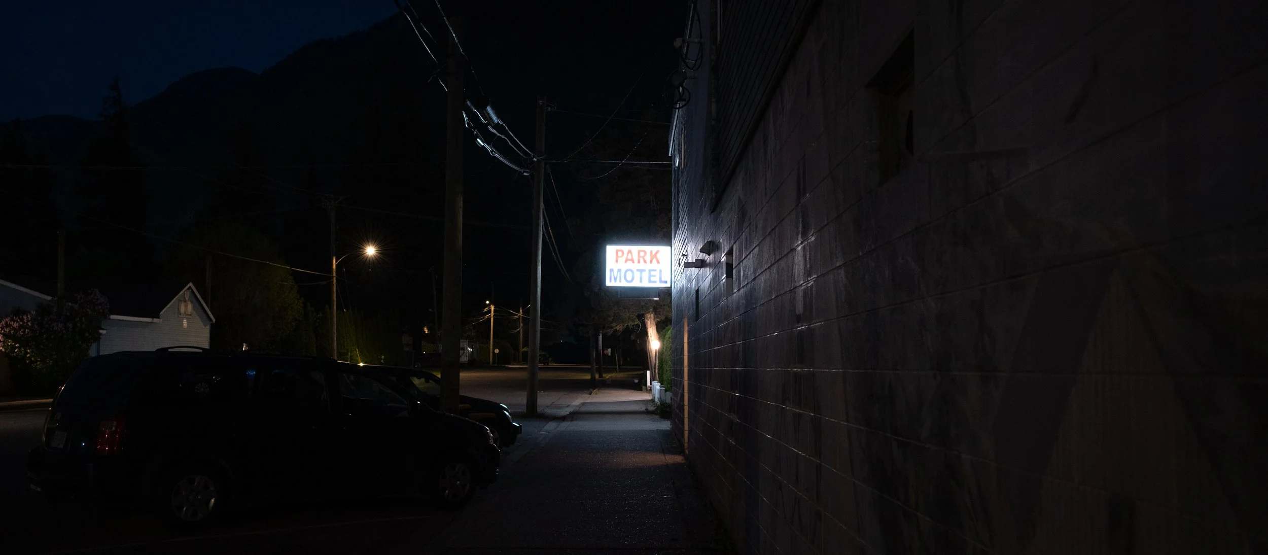 And finally, this: I really only exposed for the highlights, and honestly, I didn't think I could get anything more out of this shot. And yet, here it is, very dark, with very little visible. But there's just enough to see a dark street, dimly lit by