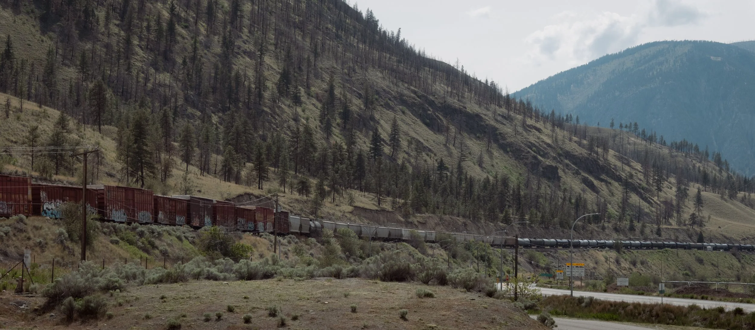 Freight train with cars as far as the eye can see in Spences Bridge