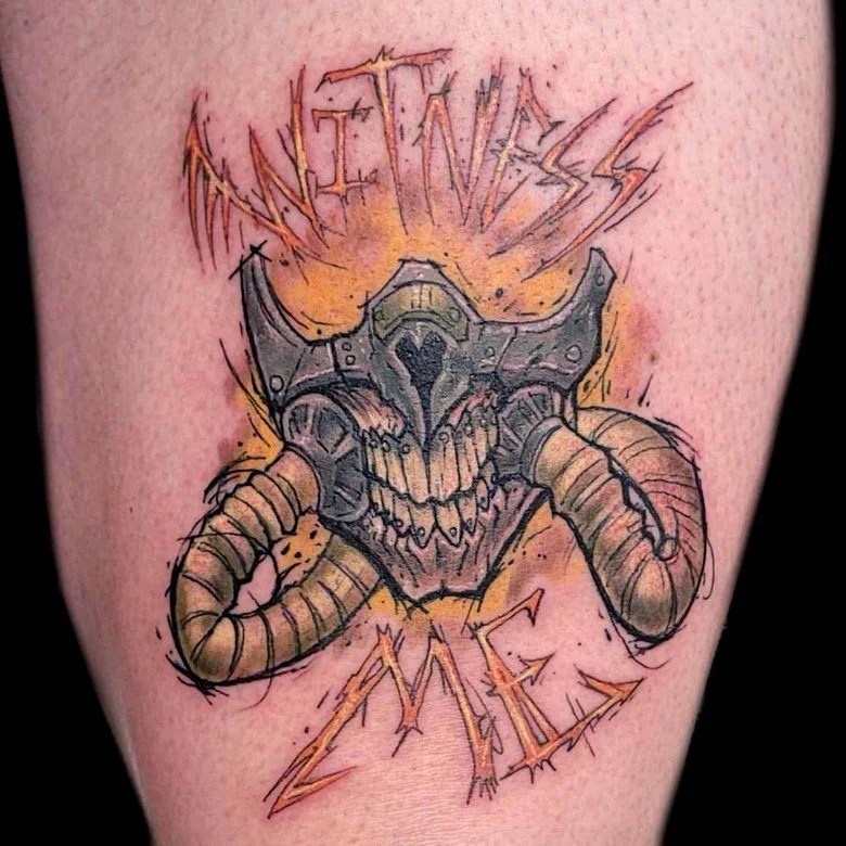 Tattoo of a cow skull with horns and a skull, with the words 'Unfiniss' and 'Zea' above and below, in a sketchy style with orange and black outlines.