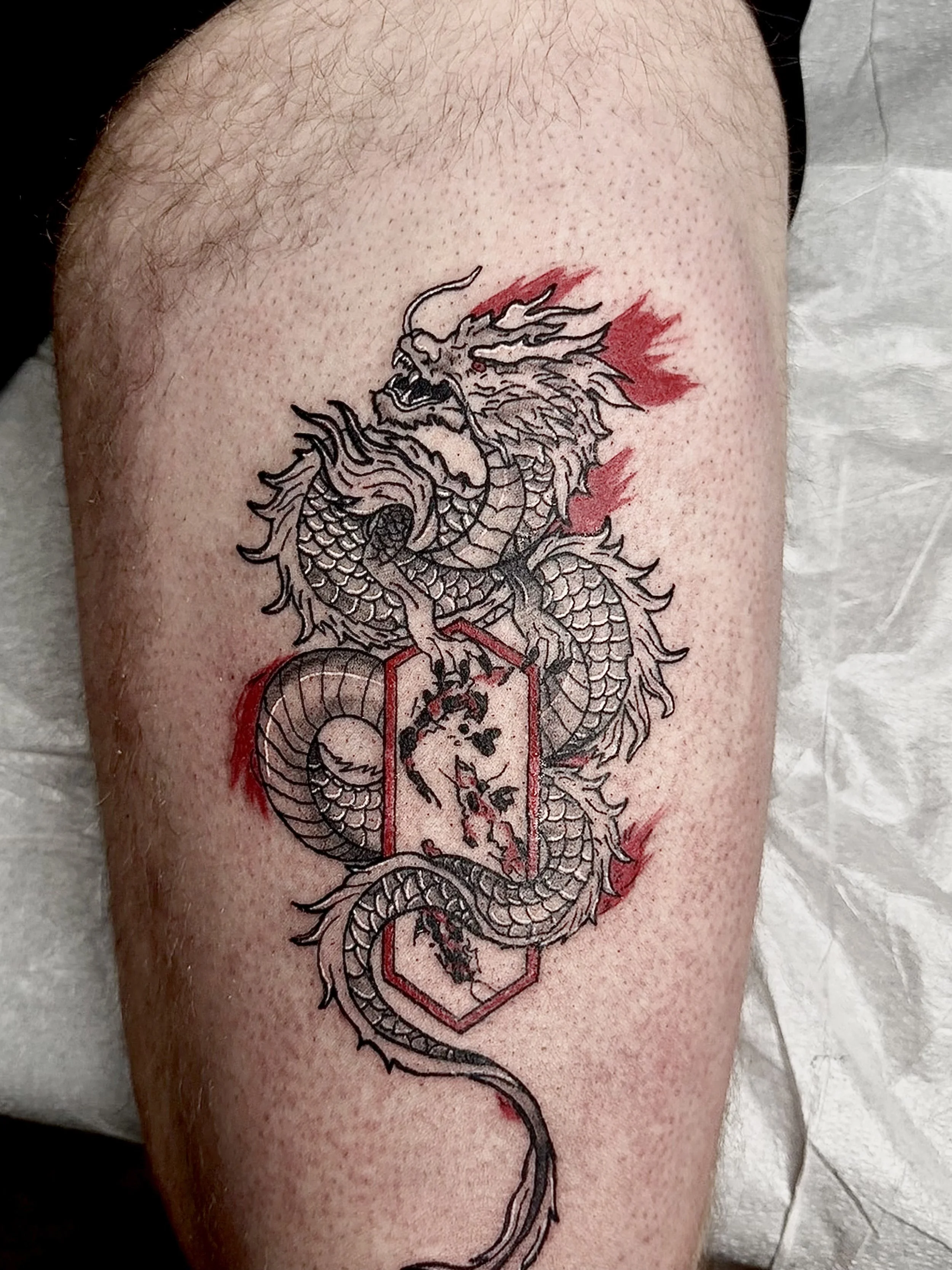 red dragon outline blackwork tattoo in edmonton.jpeg