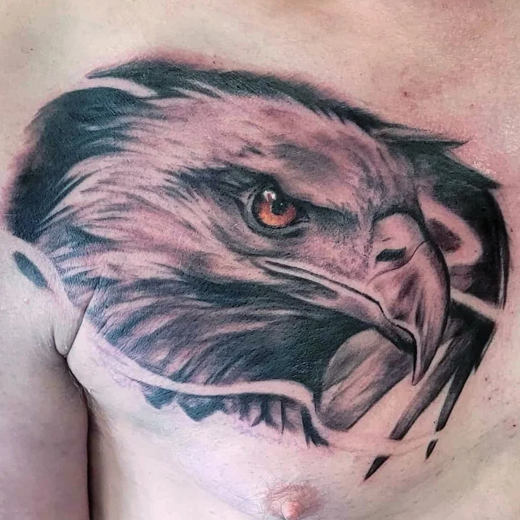 Tattoo of a realistic eagle's head on a person's shoulder.