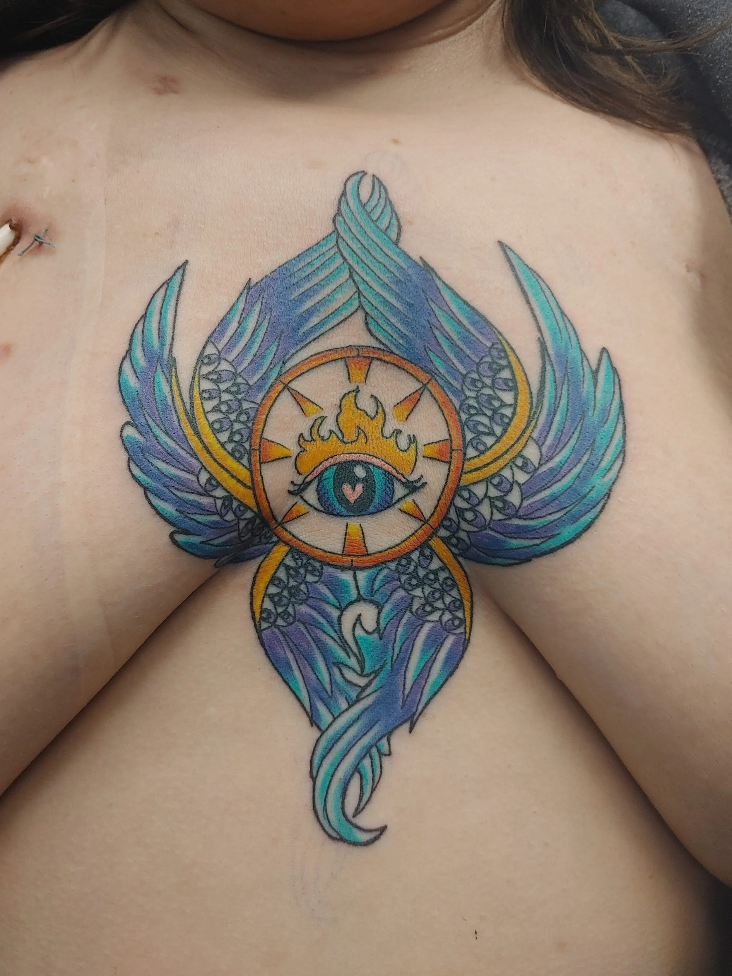 Edmonton Colorful wing sternum tattoo artist