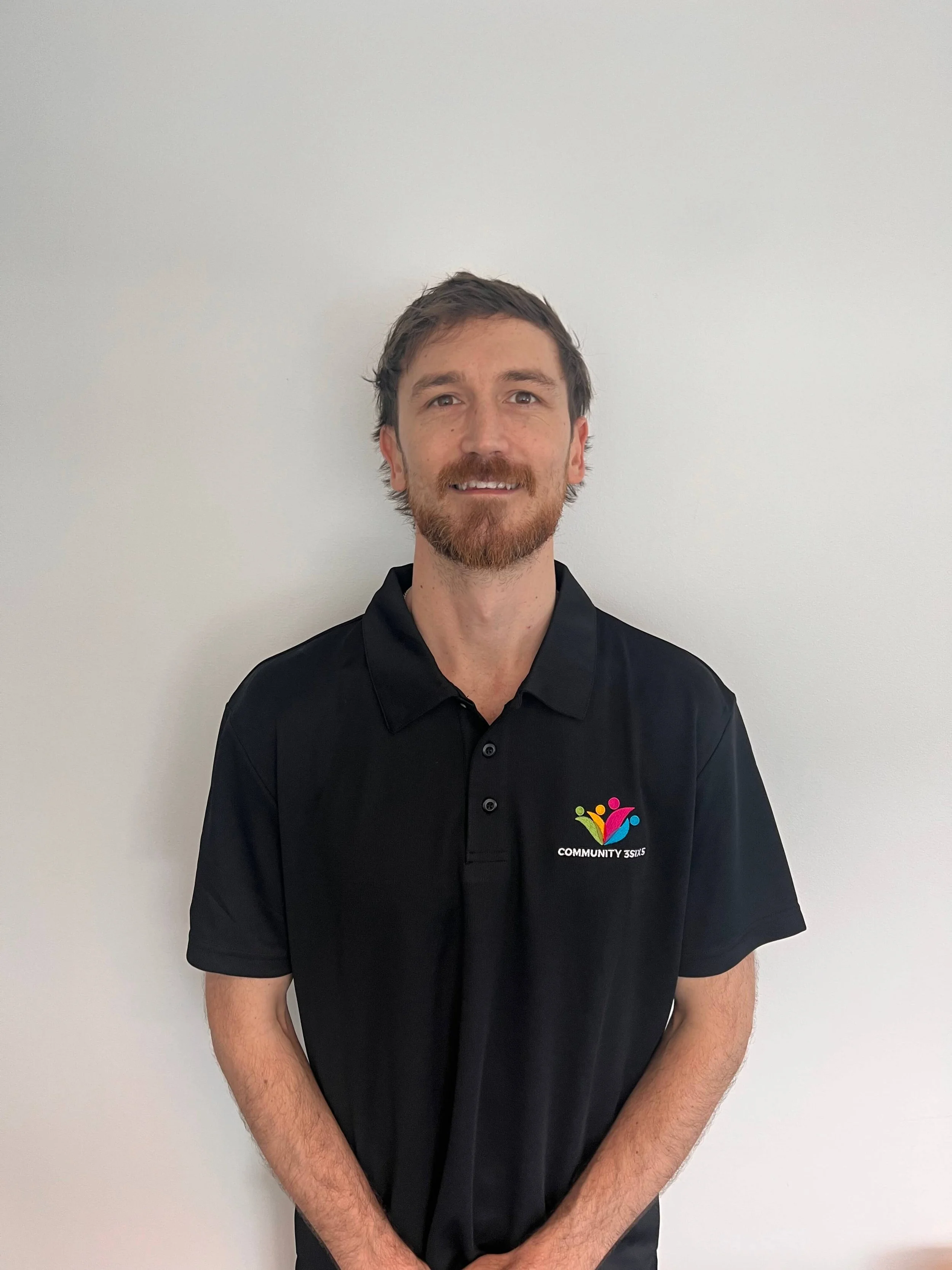 Rhys Loors smiling in his Community 3SIX5 uniform against a plain white background.