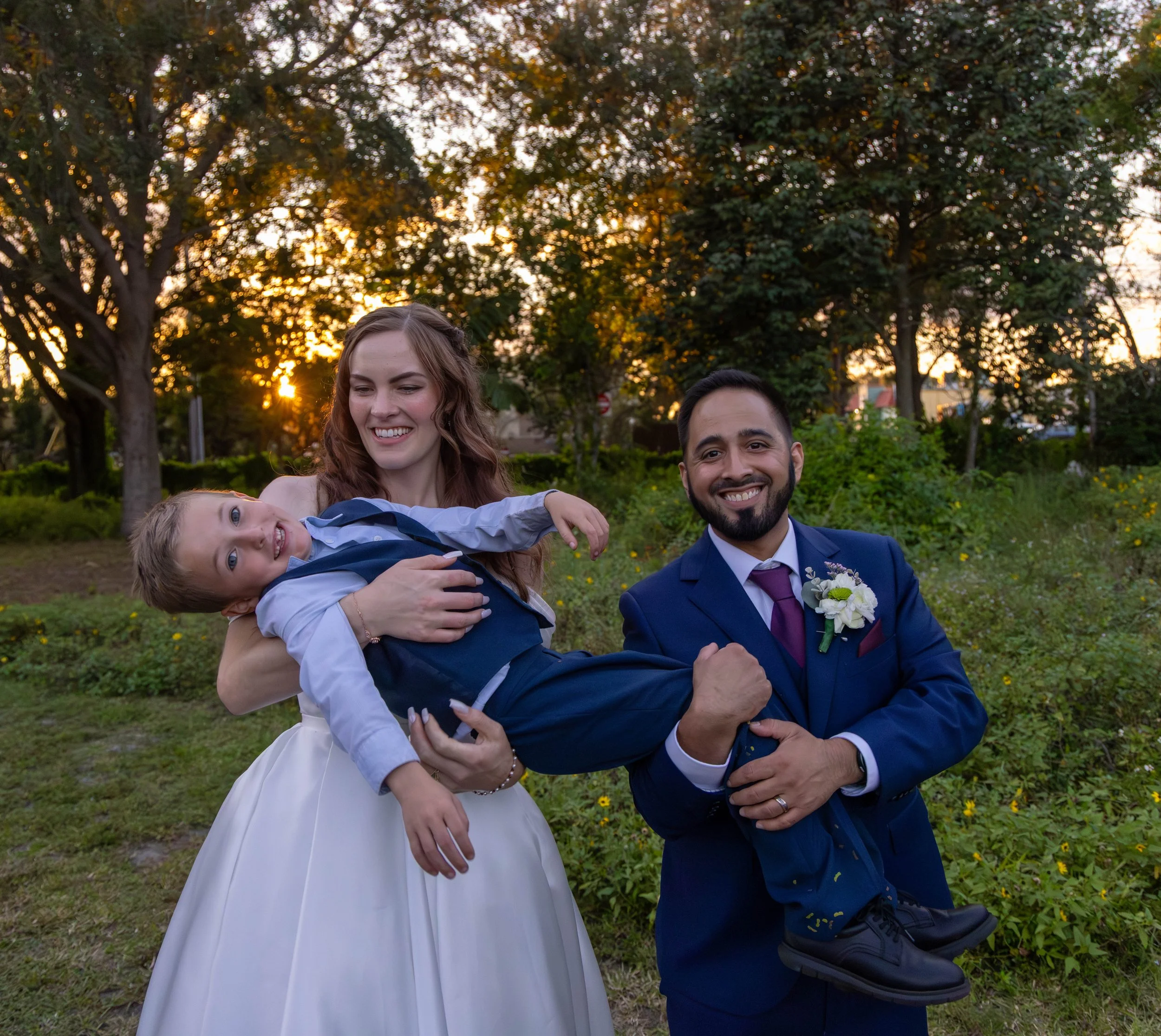 Family wedding portrait photographed outdoors during golden hour. 
