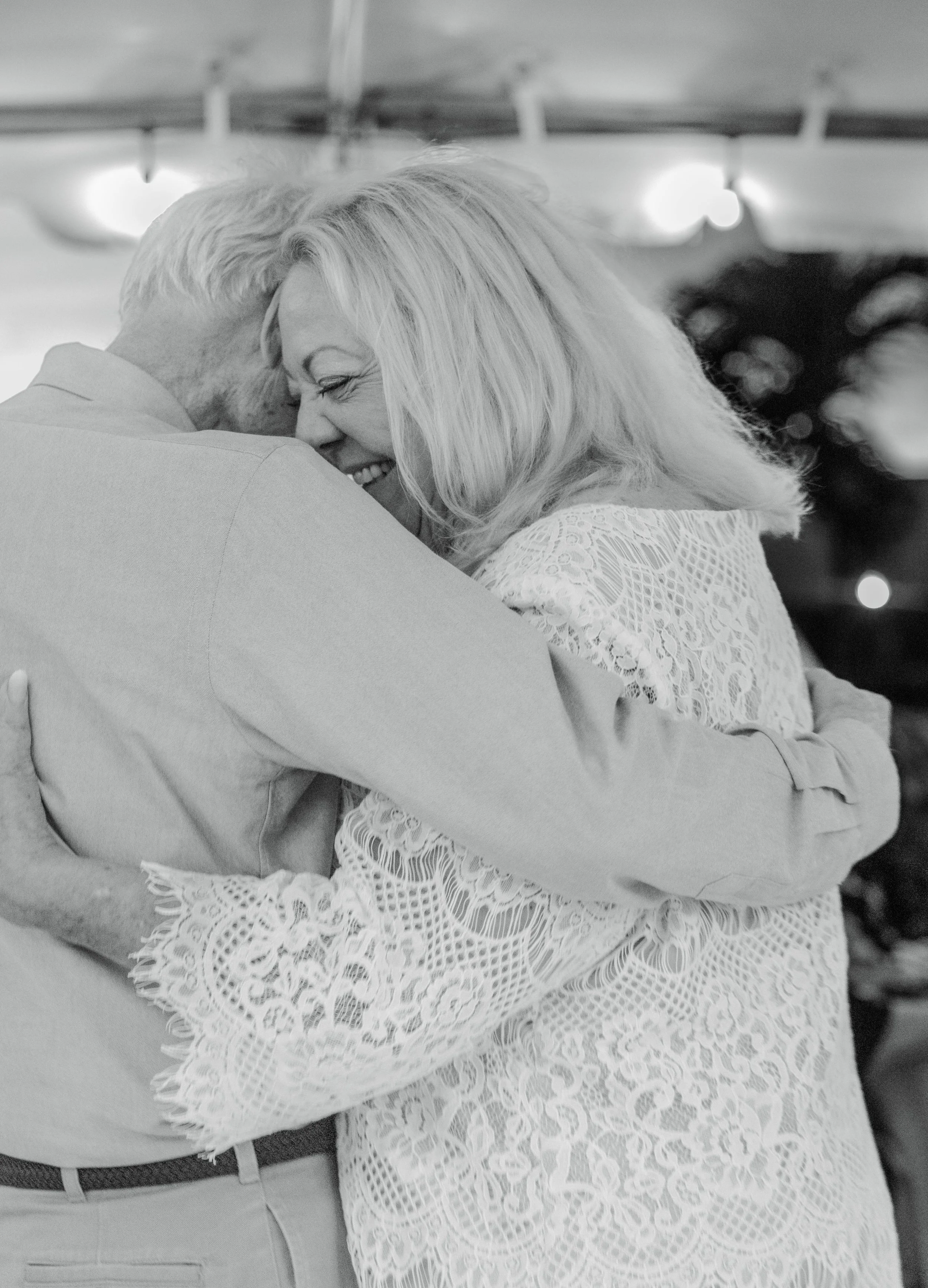 Emotional black-and-white film candid portrait of a newlywed couple. 