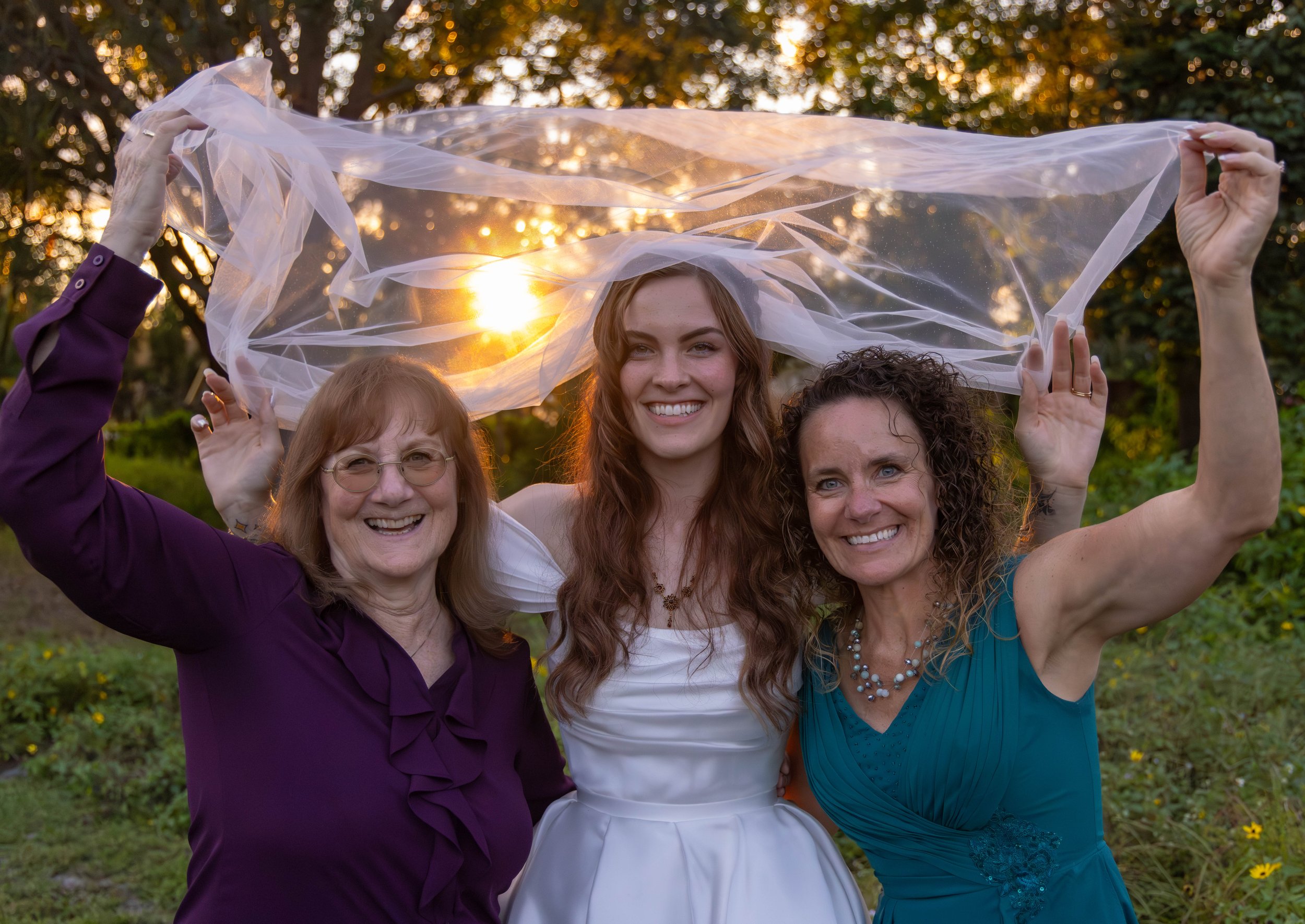 Generational celebration outdoors during golden hour wedding portraits. 