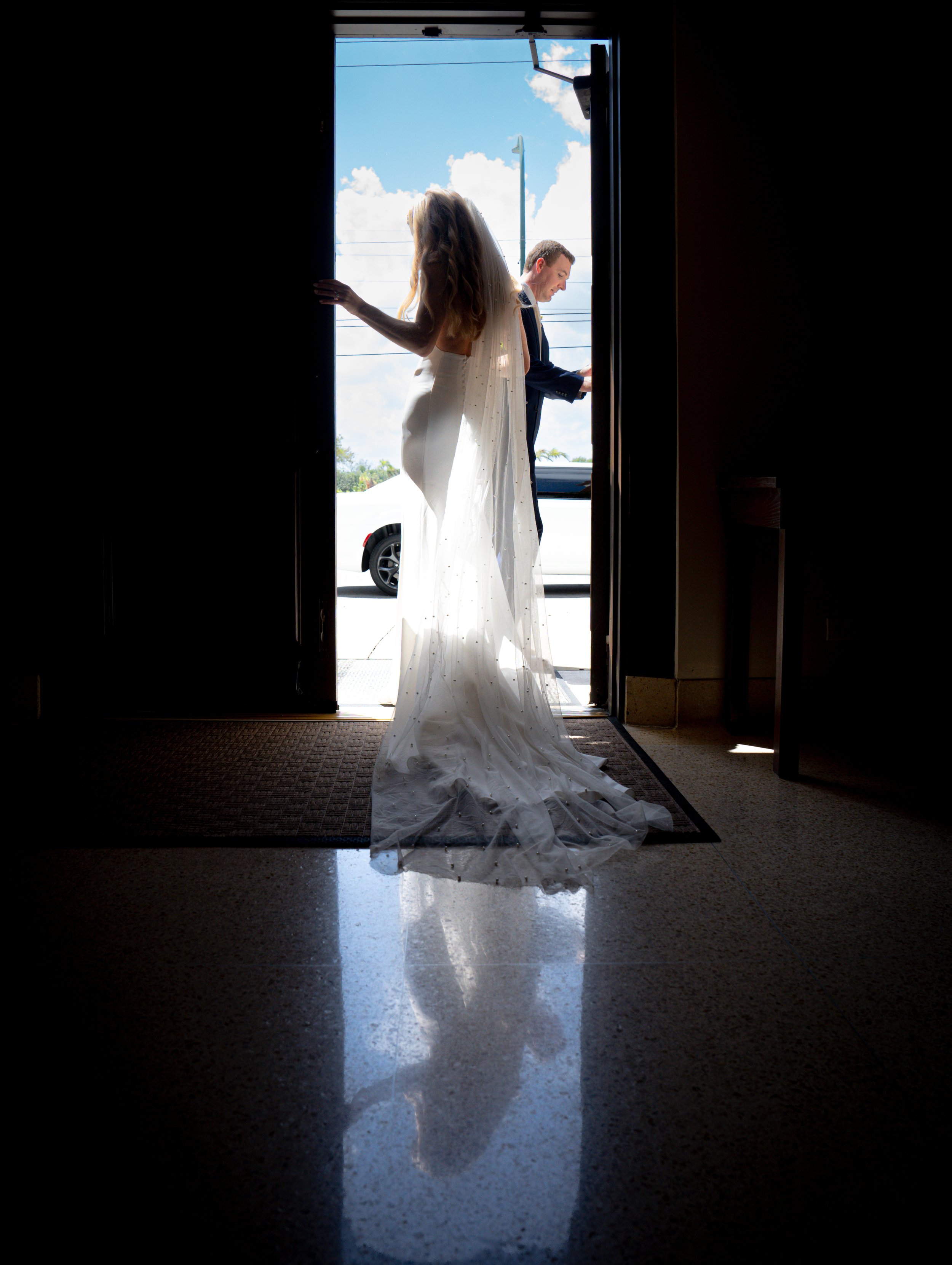 Silhouette portrait of a bride and groom during their wedding day. 
