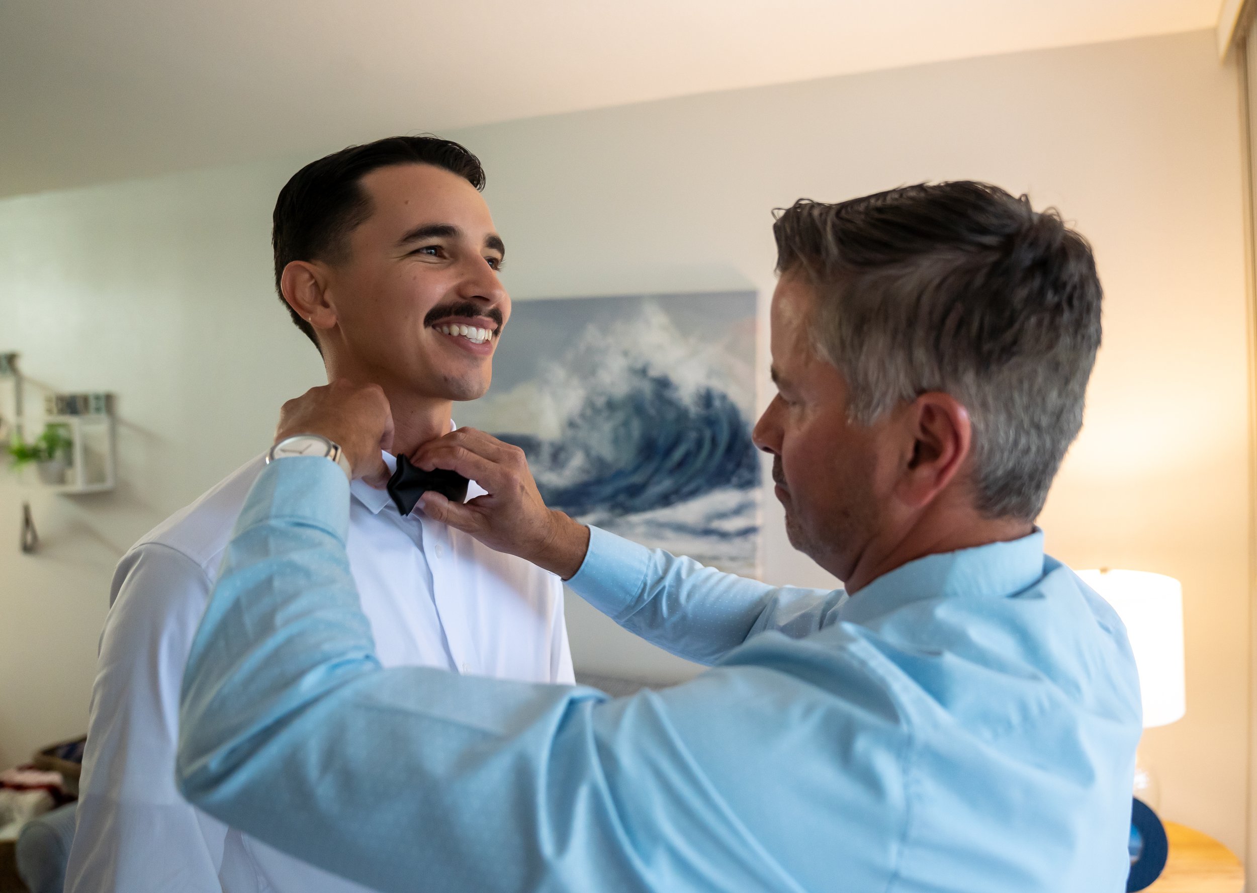 The dad helps groom prepares for his Florida beach wedding