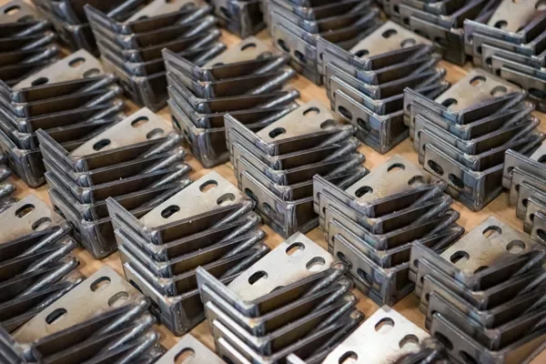 Close-up of multiple metal razor blades arranged in rows.