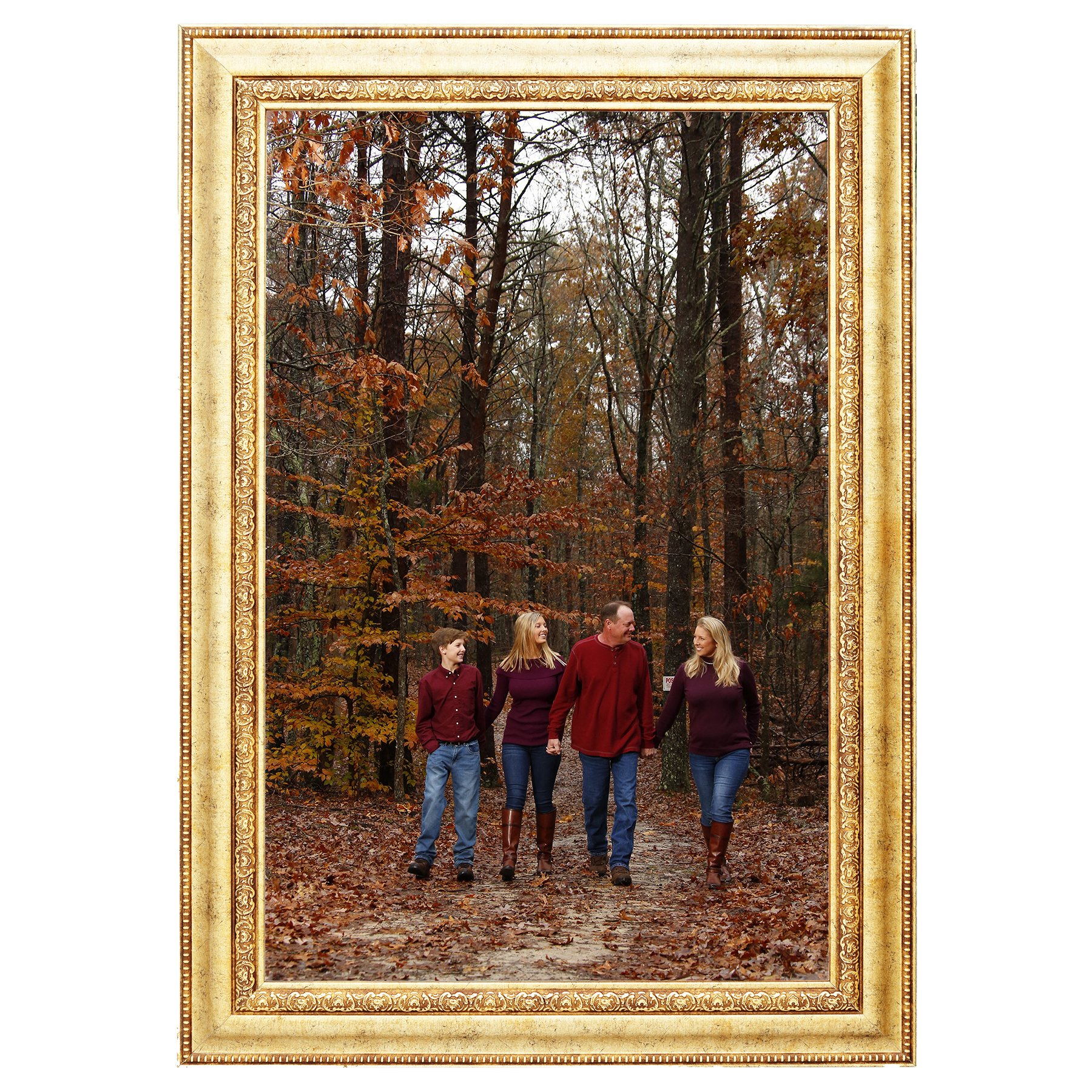 Family of four walking hand in hand along a wooded trail surrounded by colorful autumn foliage, photographed by Hayes & Fisk Photography.