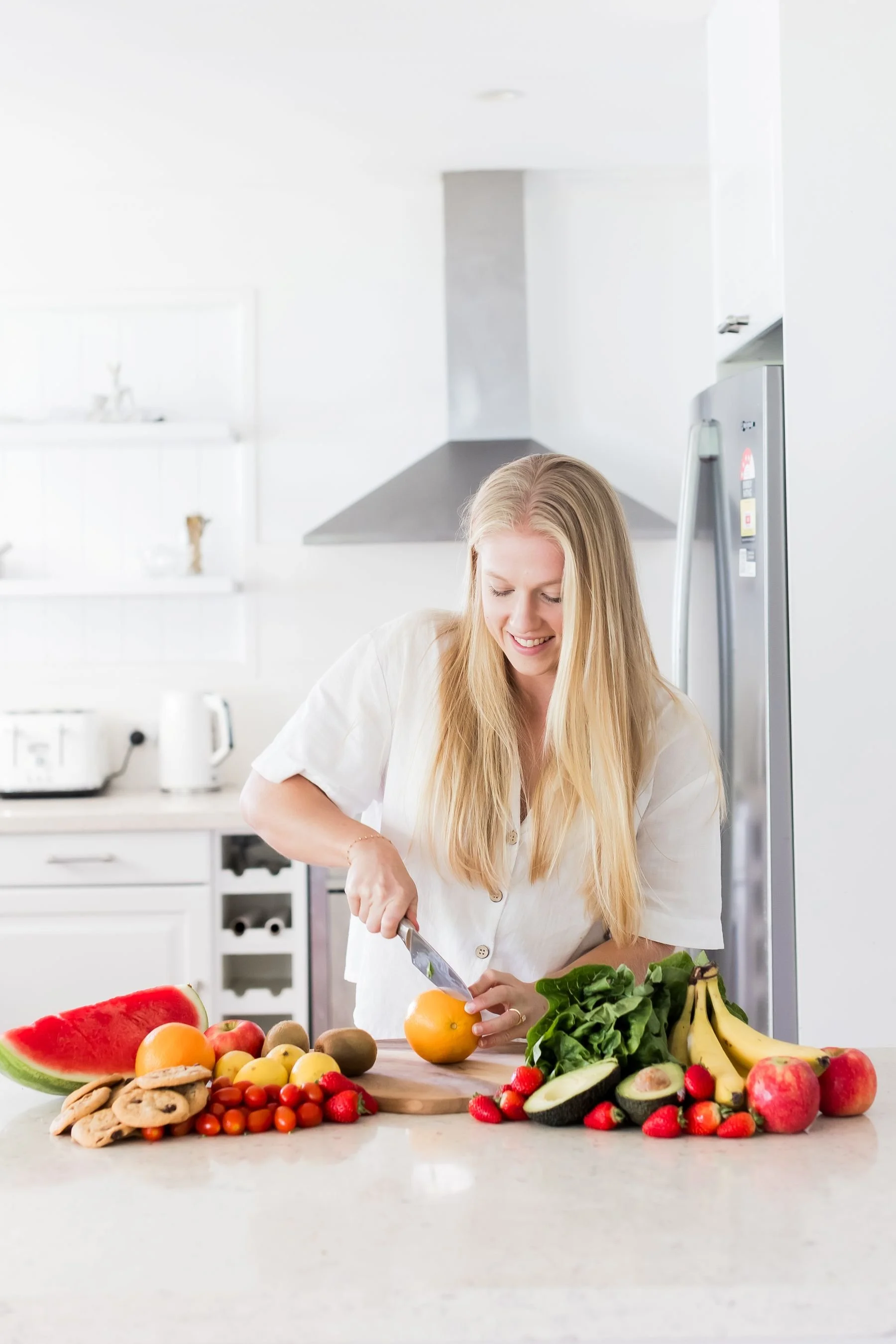 sunshine coast dietitian women cutting orange