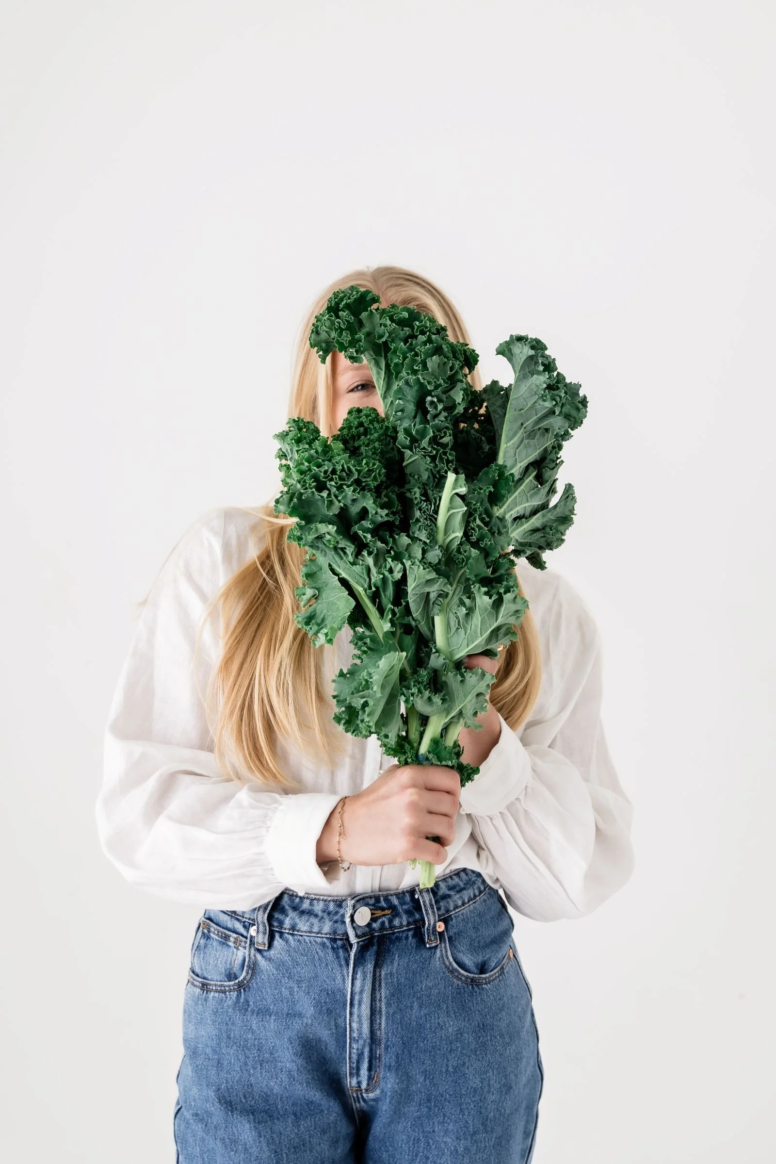 sunshine coast dietitian women hiding behind kale