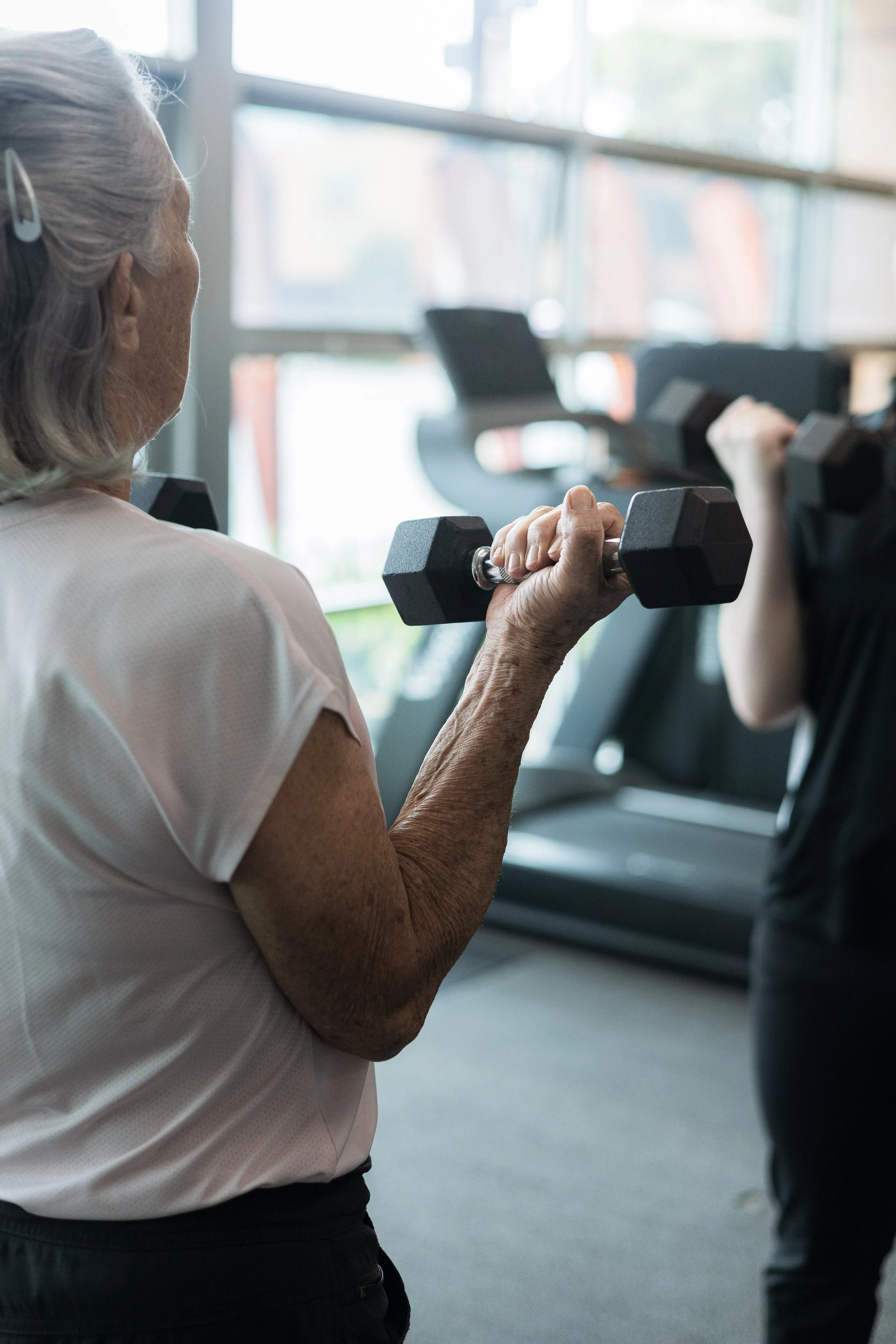 Client with Tegan Berry-Smith using dumbbells during Balance and Falls Adelaide class, Resilient Health Group, 226 Magill Road, Beulah Park SA 5067. Balance & Falls Prevention Adelaide.
