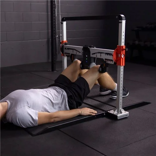 Person performing a deadlift exercise in a gym with a deadlift training bar and frame.