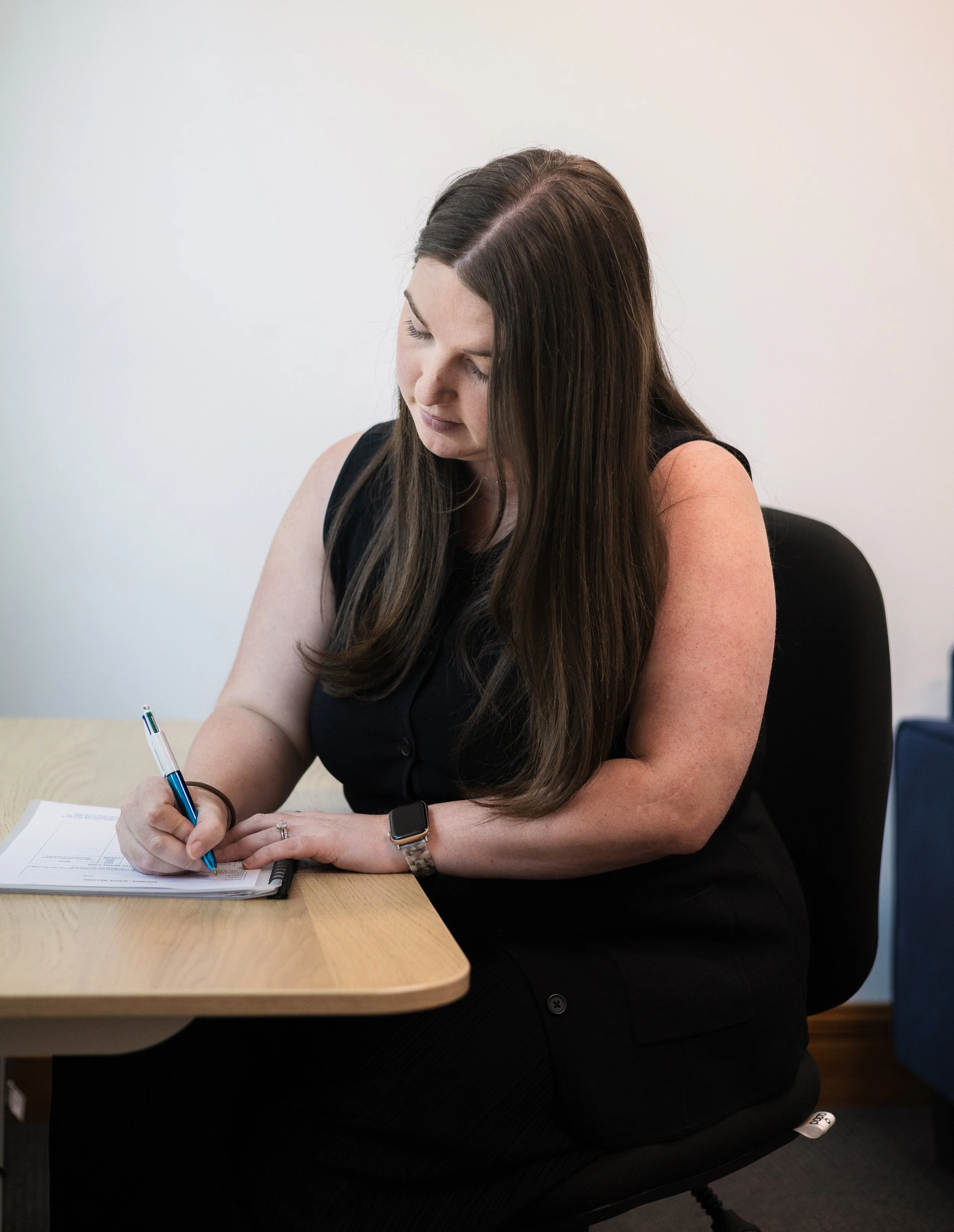 Tiffany Watson, our highly-regarded Speech Pathologist in office taking notes. Resilient Health Group, 226 Magill Road, Beulah Park SA 5067. Speech Pathology Adelaide.
