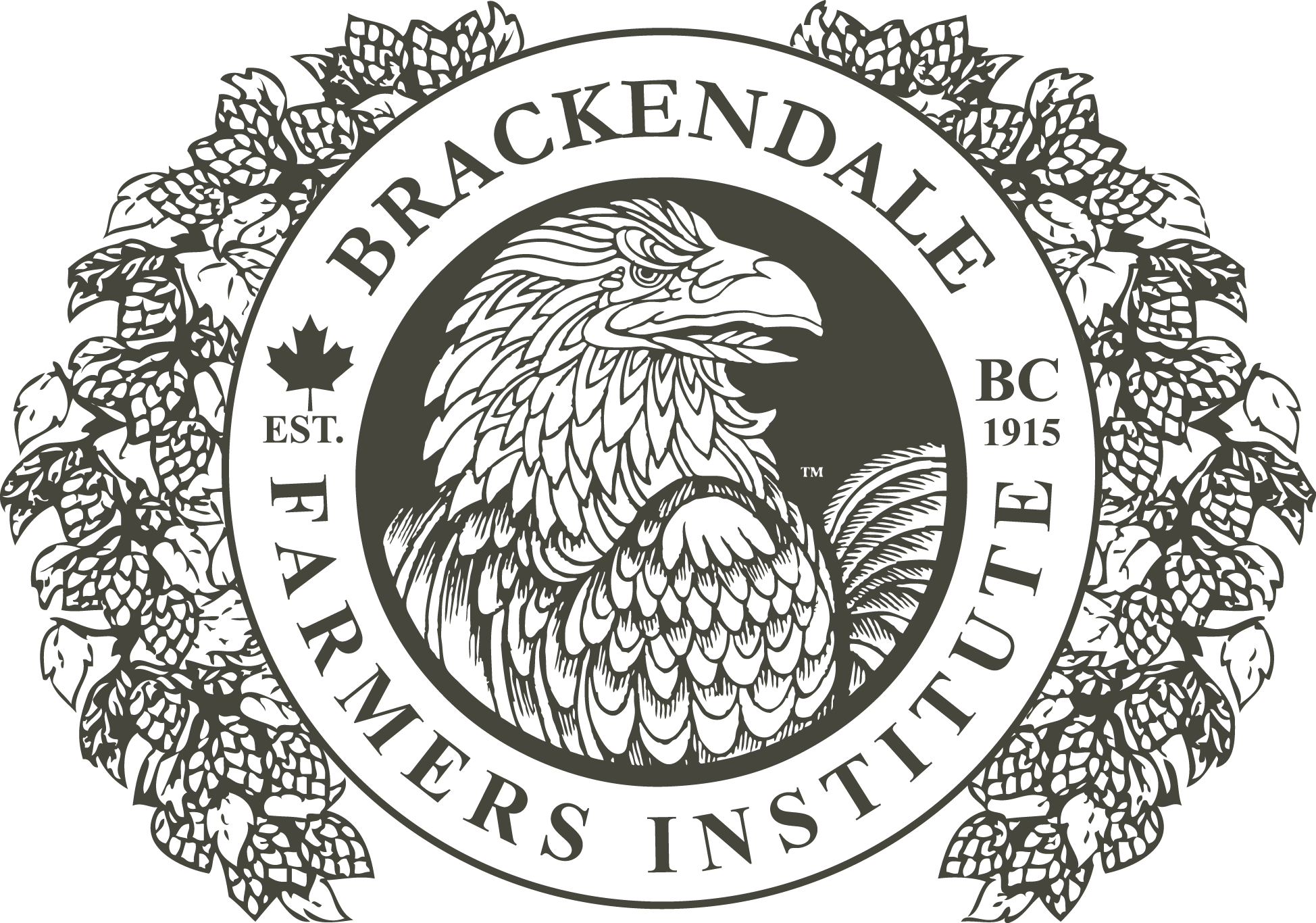 Mountains in the distance across a body of water with trees and a building in the foreground.