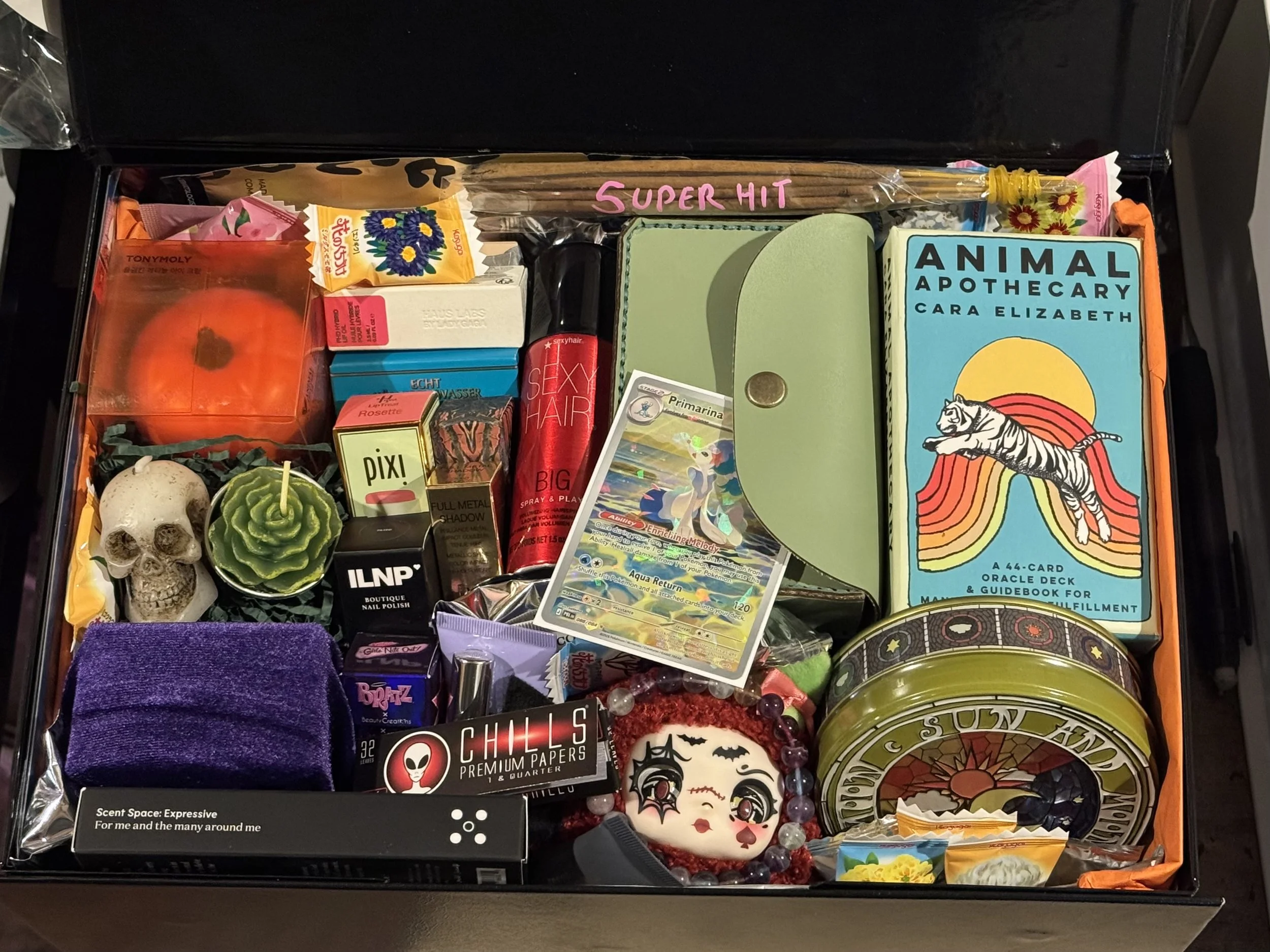 Luxury Gift Box featuring a Rider Waite Tarot in handmade pistachio leather case, Animal Apothecary Oracle, Tonymoly Plumpkin Retinol Eye Cream, Versace Crystal Noir, Lip tints, ILNP Tilted Nail Polish, YSL Eyeshadow, Hand-poured Ceramic Sea Salt Can