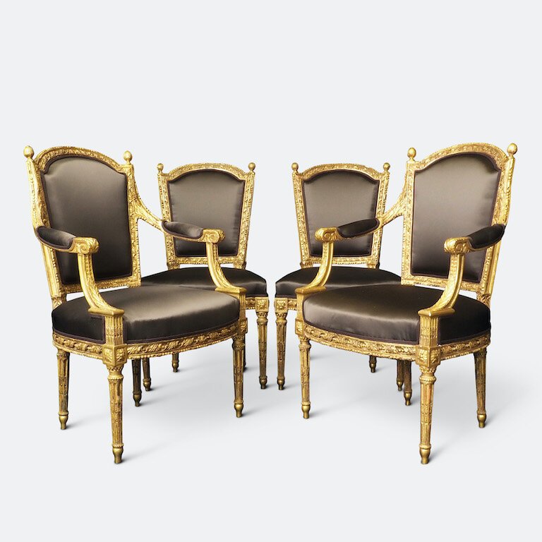 A Louis XV gilt-wood salon suite comprising four armchairs and a