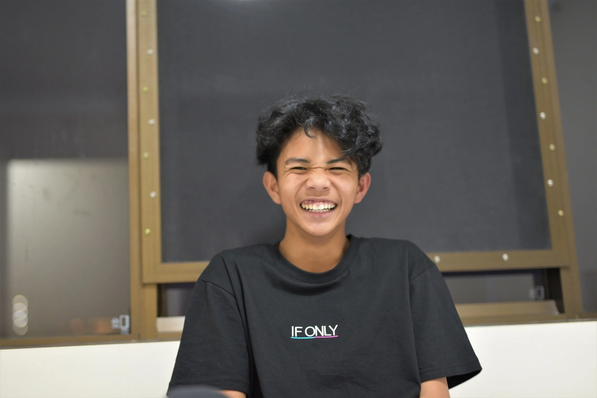 A laughing youth showing the effects child therapy in Kitchener and adolescent therapy in Kitchener can have