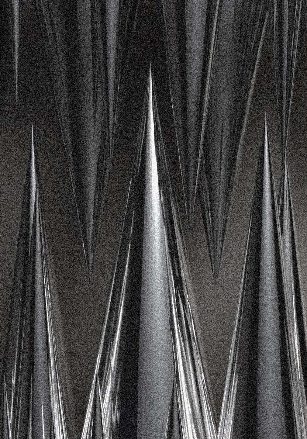 Close-up of a metallic surface with sharp, elongated triangular and pointed shapes and reflections.
