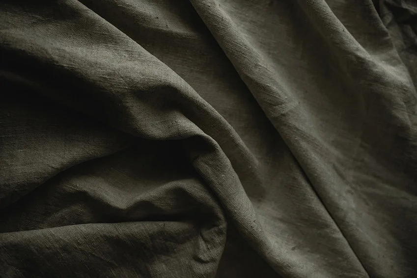 Close-up of dark, wrinkled fabric or cloth.