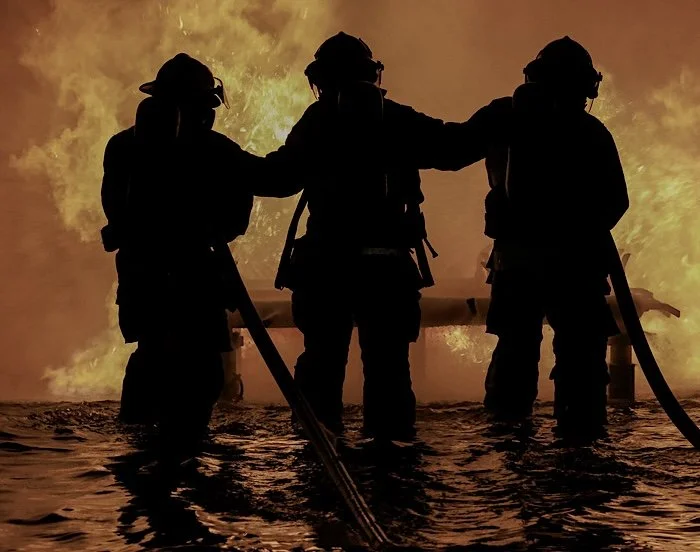 Firefighters operating in high-stress conditions illustrating real-world sleep performance, recovery, and fatigue management