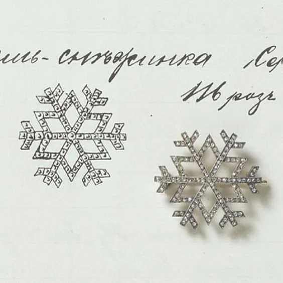 Platinum and diamond snowflake pendant by Faberge next to its entry in the stock book  