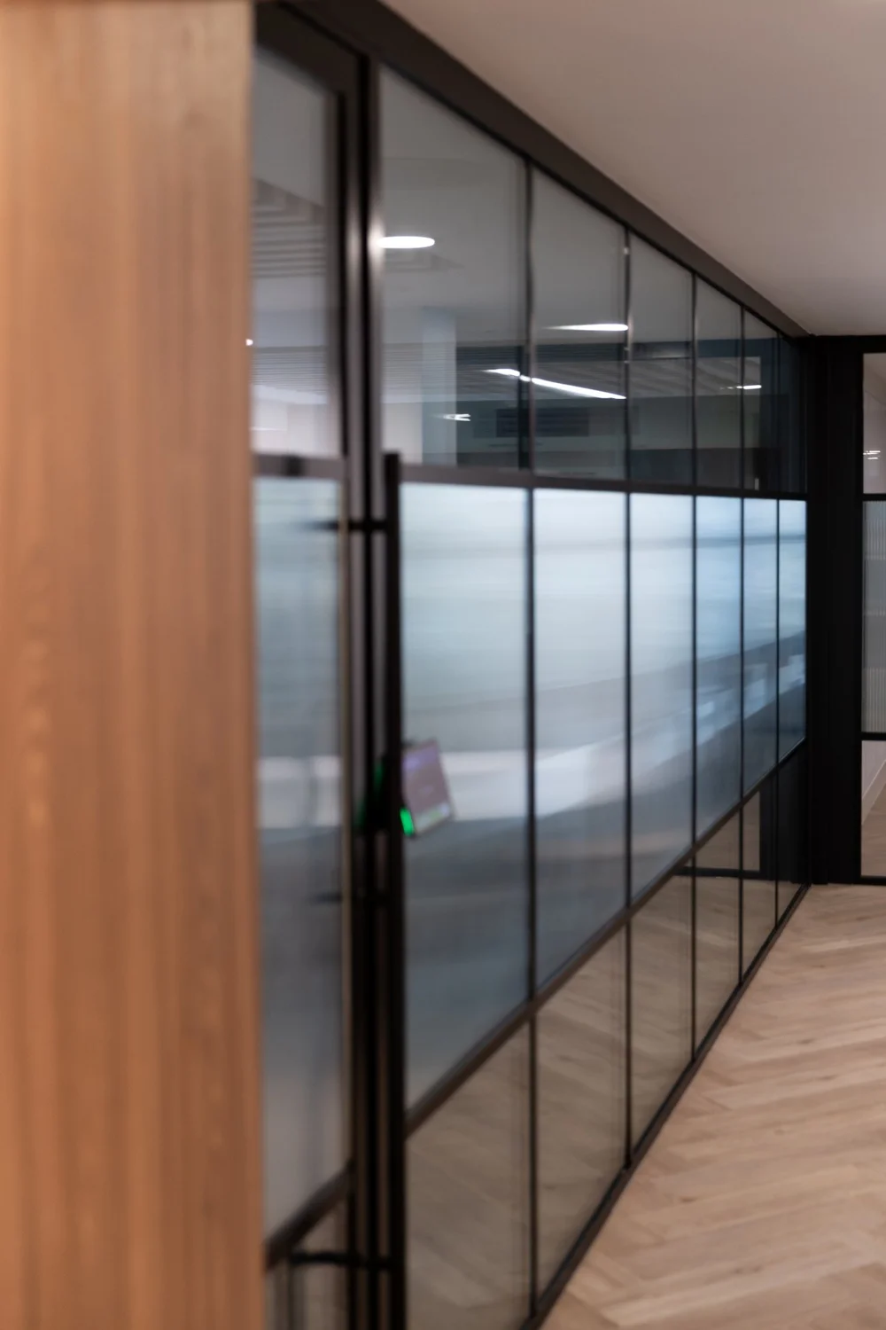 Timber-lined entrance to glazed meeting rooms