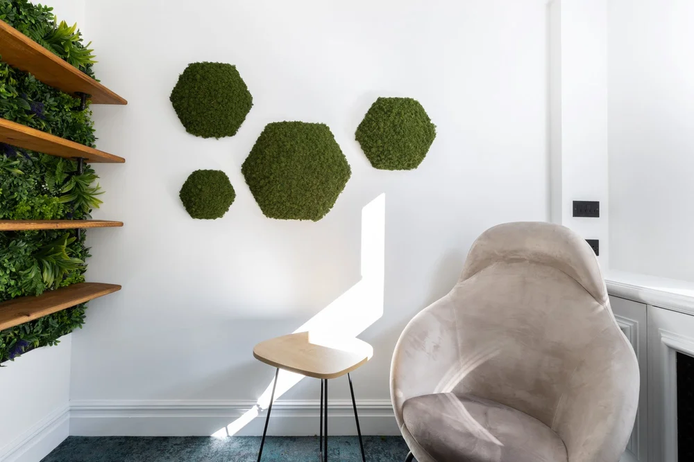High-back chair and green wall panels in the one-to-one room