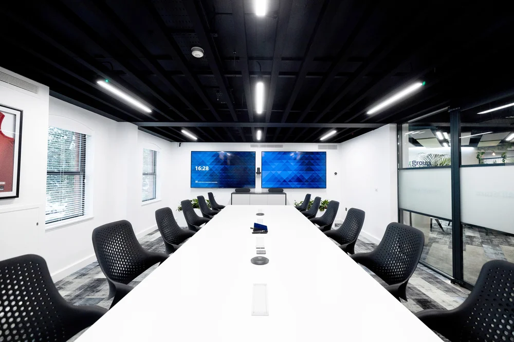 Boardroom with screen and integrated meeting technology
