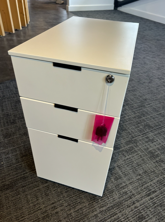 White metal three-drawer mobile pedestal with recessed drawer pulls and keys, actual sale item