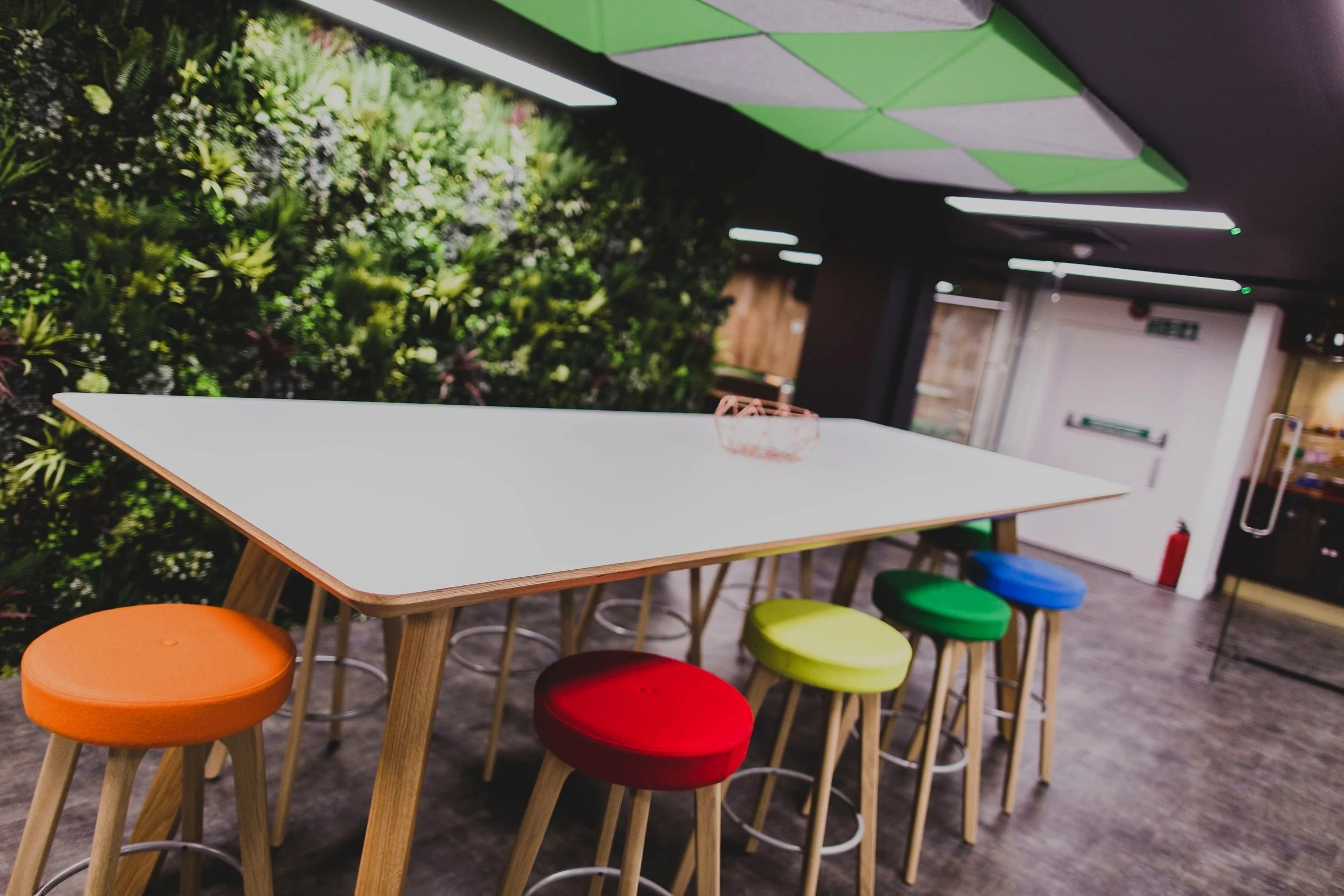 Jumpman Gaming Case Study: Breakout area featuring acoustic ceiling panels and Greenwall panels within the Jumpman Gaming office space, innovatively transformed by POS Interiors.
