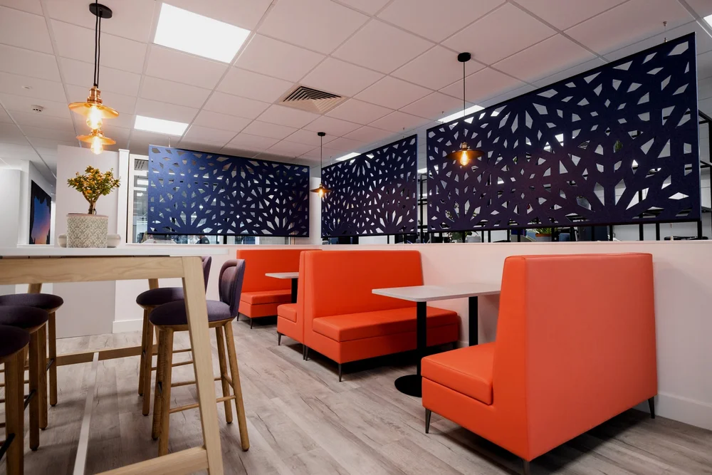 Sequent kitchen and social area with blue finishes and orange seating