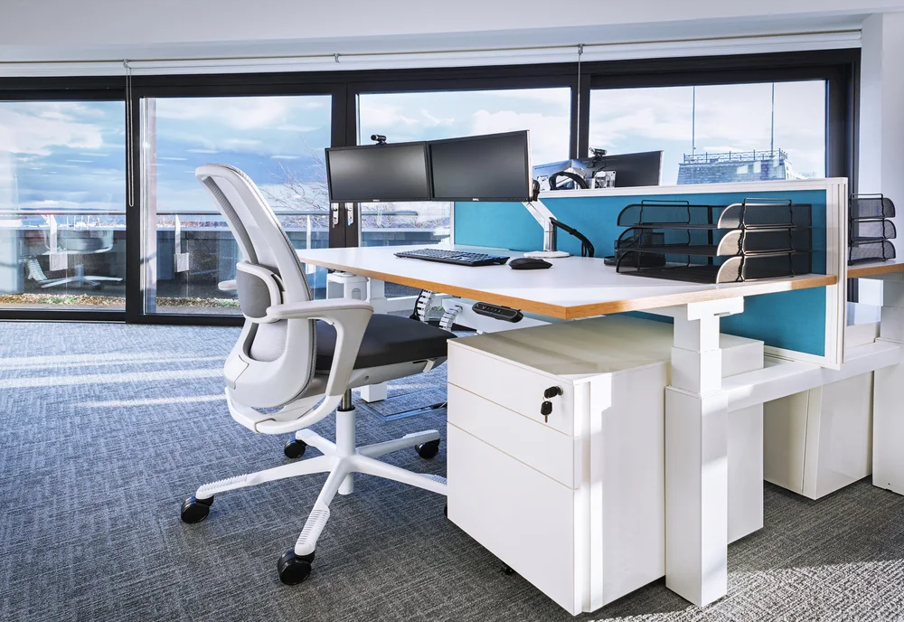 Sit-stand desk with personal storage and task chair