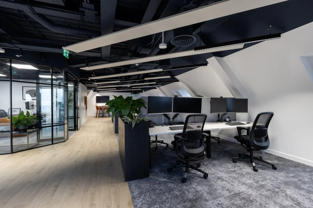 Workstations beneath exposed ceiling services