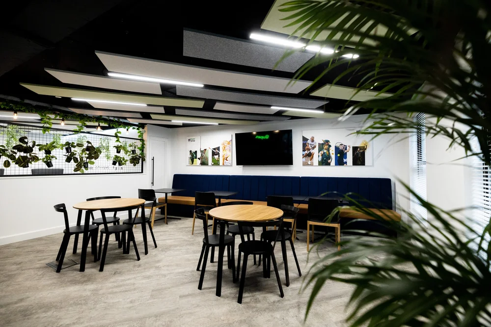 Shared social space with acoustic ceiling panels at Super Group