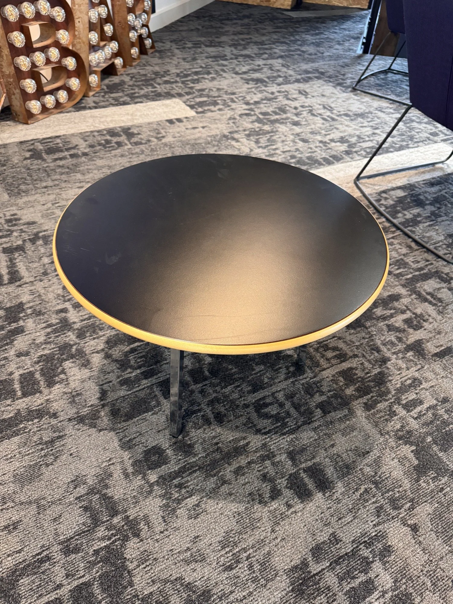 Materia round coffee table with black top and chrome frame, actual sale item
