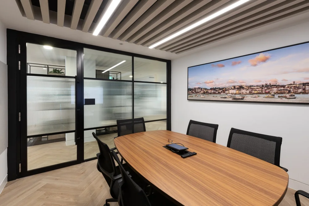 Meeting room with acoustic ceiling treatment and integrated screen