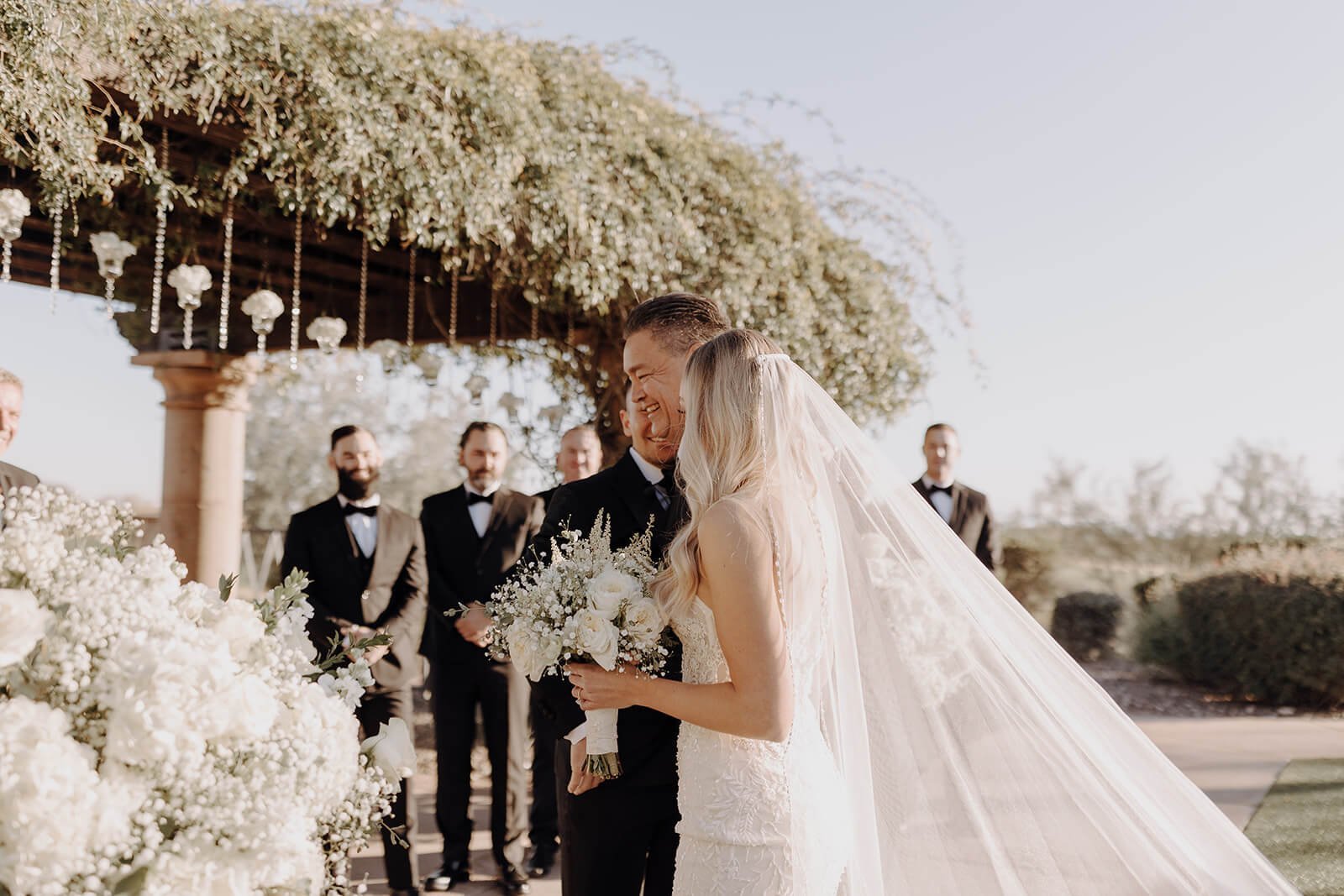 Bride and her father standing at the front of the ceremony aisle at an outdoor wedding in Arizona