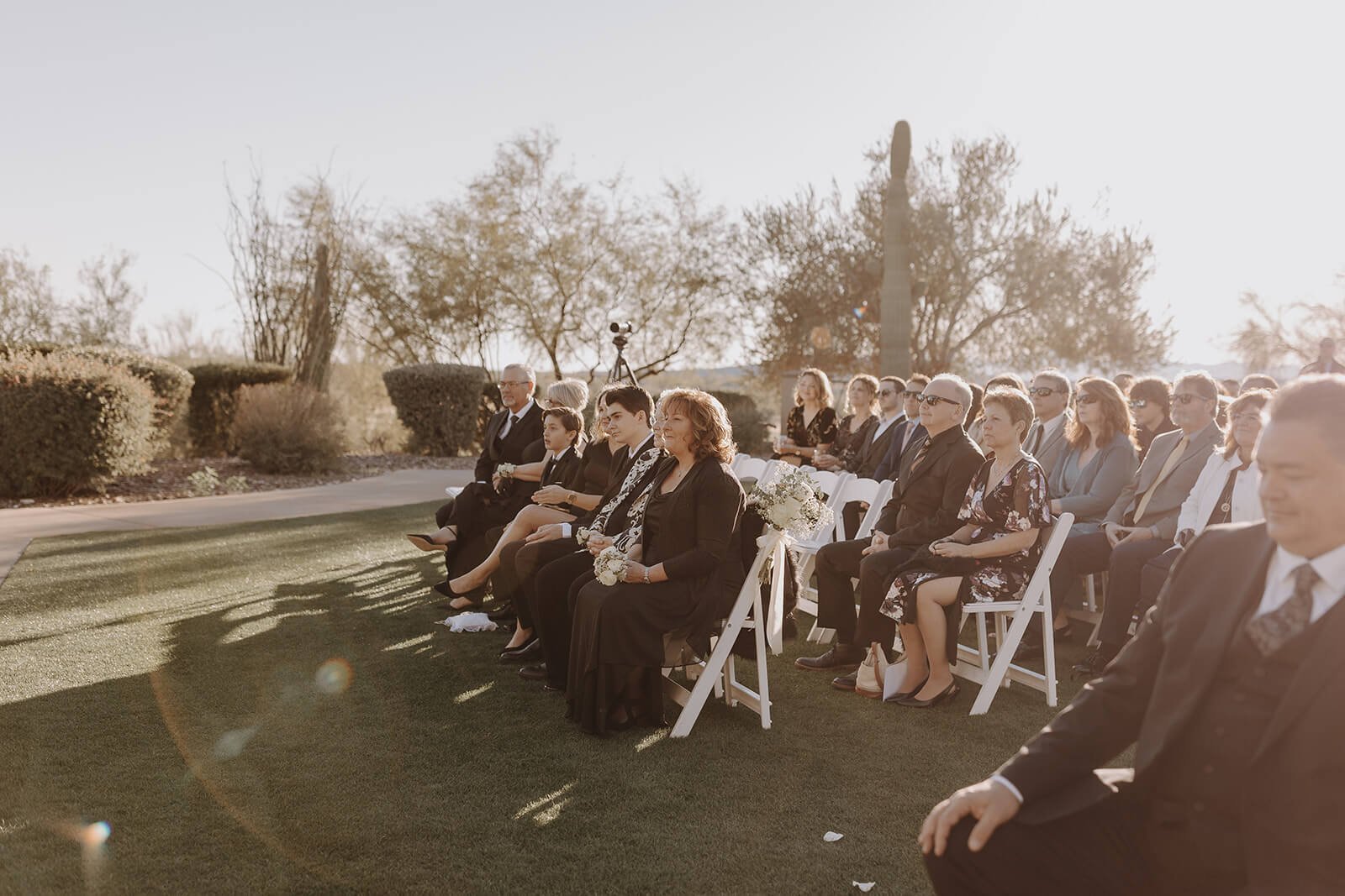 Wedding guests watching ceremony at classy black and white outdoor wedding in Arizona