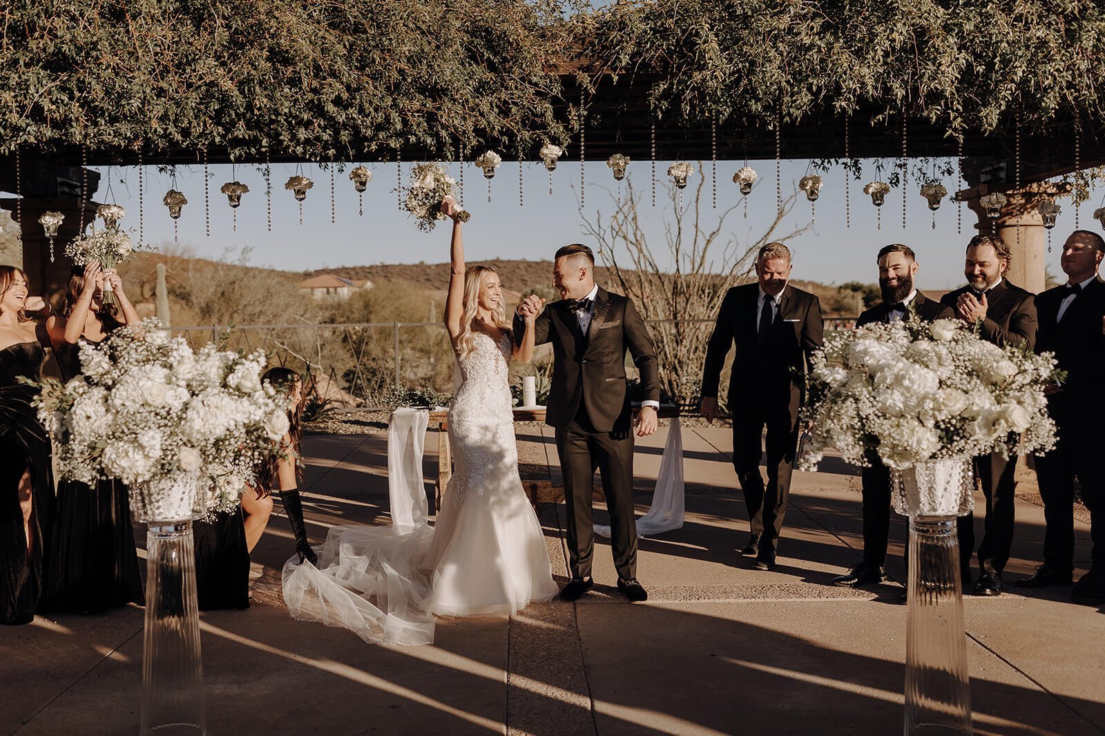 Bride and groom under wedding arbor at outdoor wedding at Blackstone Country Club in Arizona