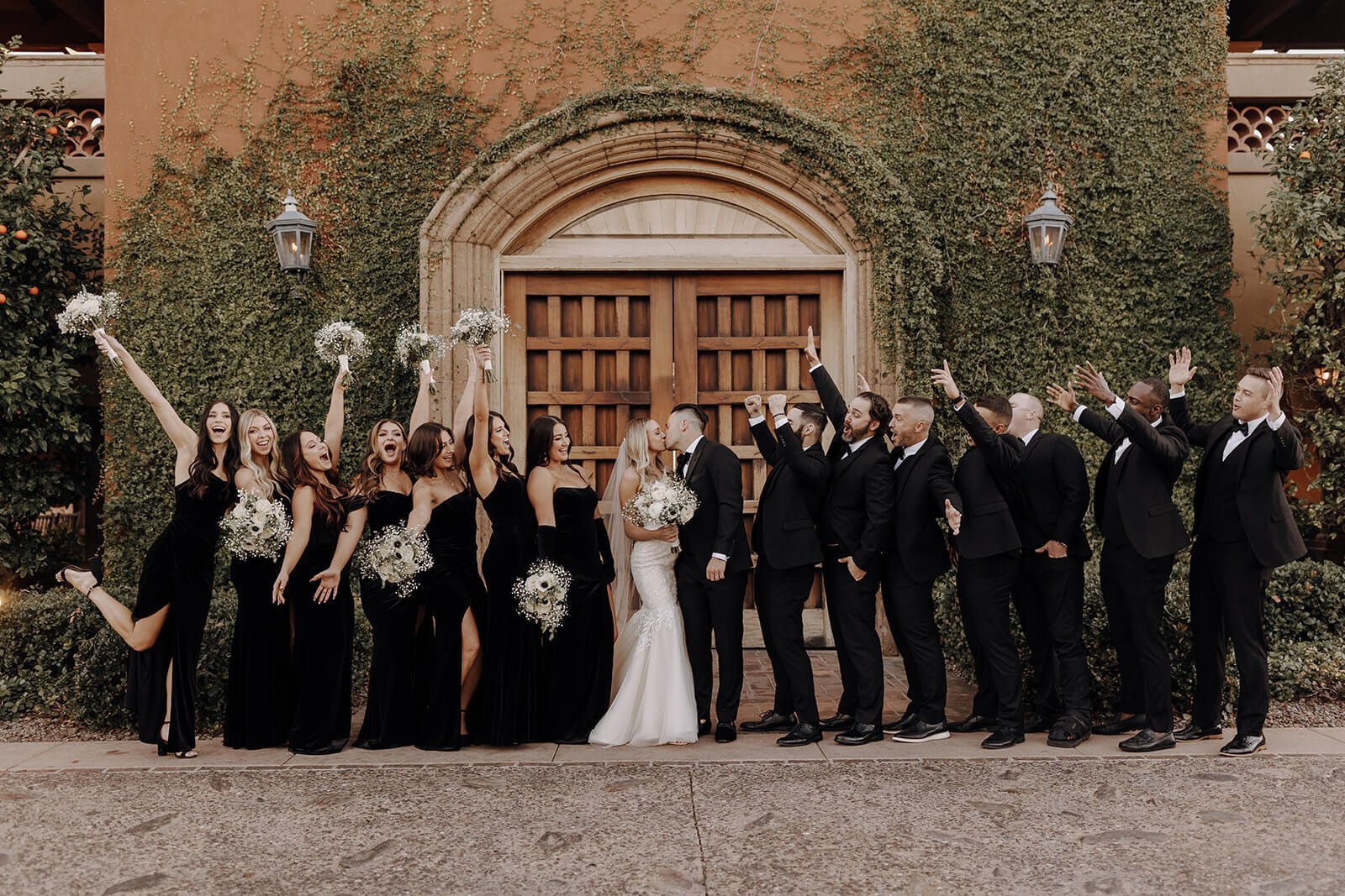 Wedding party celebrating with bride and groom at classy black and white Arizona wedding