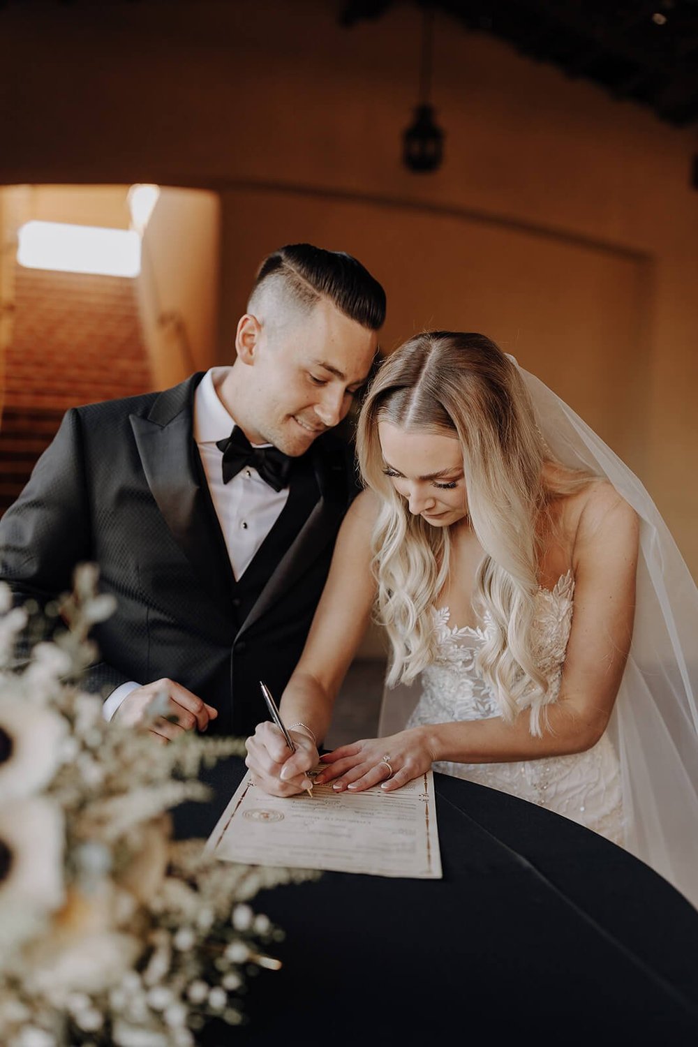 Bride and groom signing marriage license at Blackstone Country Club wedding