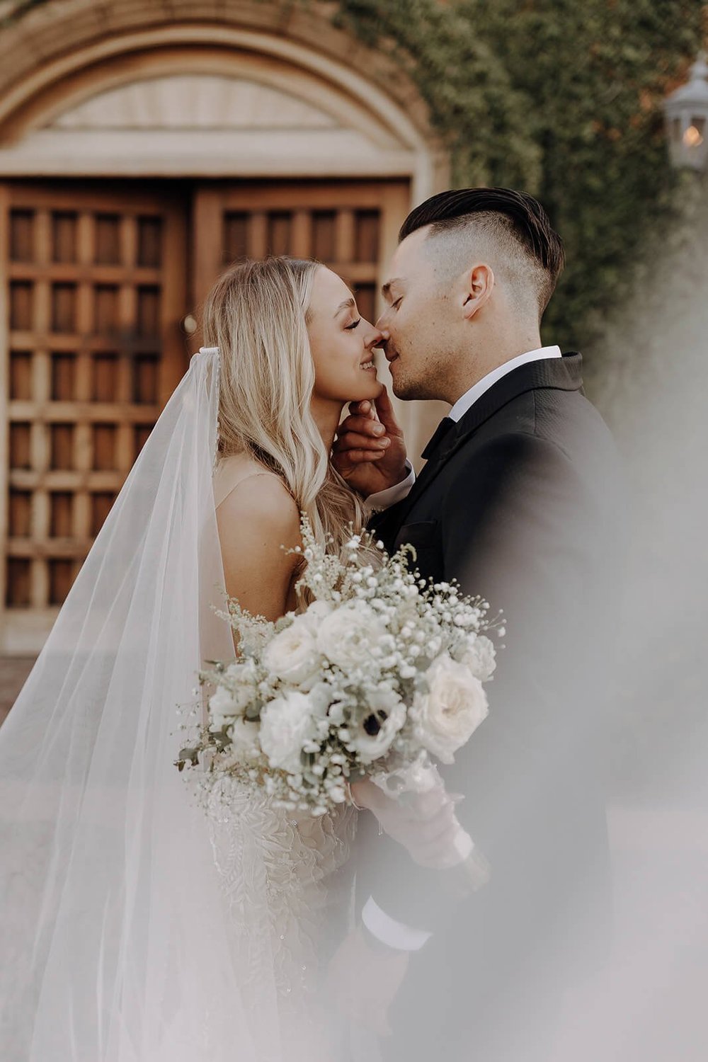 Bride and groom kissing in courtyard at Blackstone Country Club in Arizona