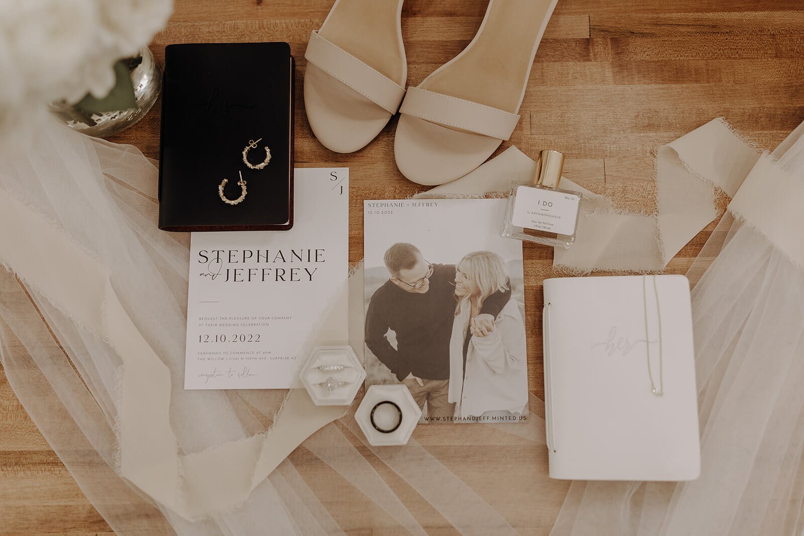 Wedding invitation flat lay with wedding shoes and jewelry